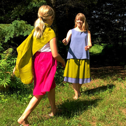 2 Light Weight Cotton Slips layered together as a skirt - shorter length in Shanti Green and longer length in Steel Blue, Reversible Sleeveless Top in Steel Blue with Maroon on the inside<br>Little Girl with Sunset Pink Slip and a Shanti Green Devinity Scarf